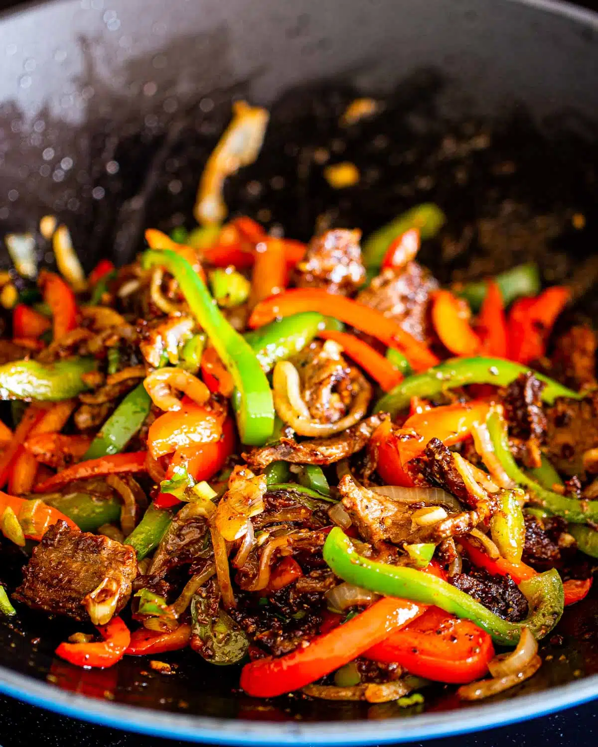 asian style pepper steak in a wok.