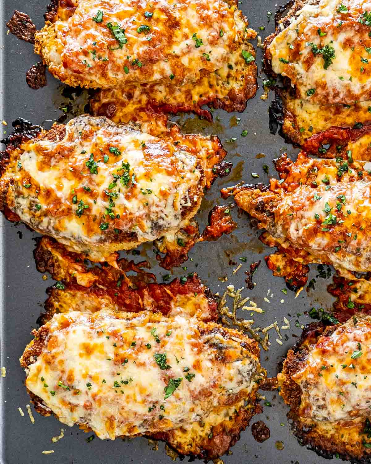 chicken parmesan on a baking sheet fresh out of the oven.