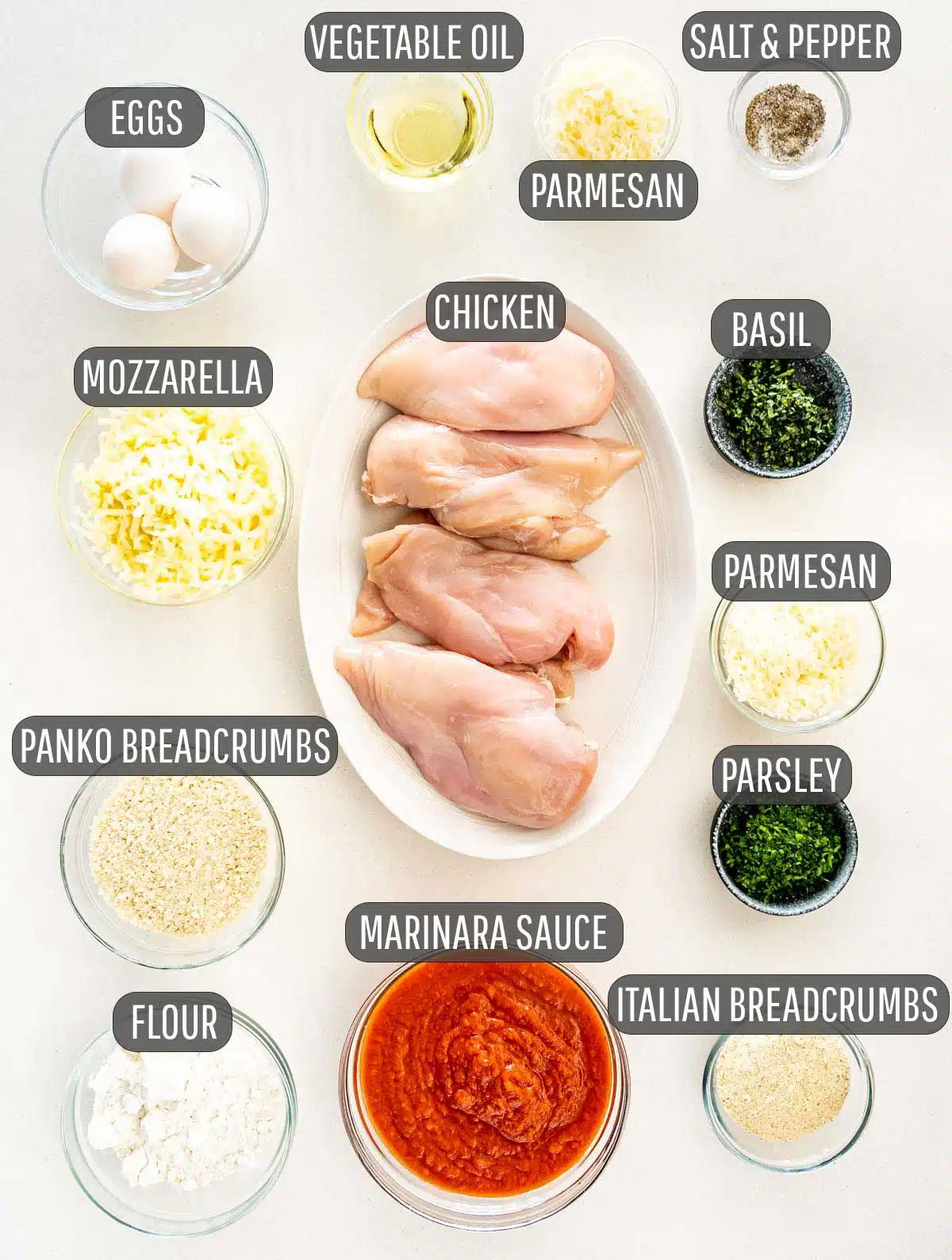 all the ingredients lined up that are needed to make chicken parmesan.