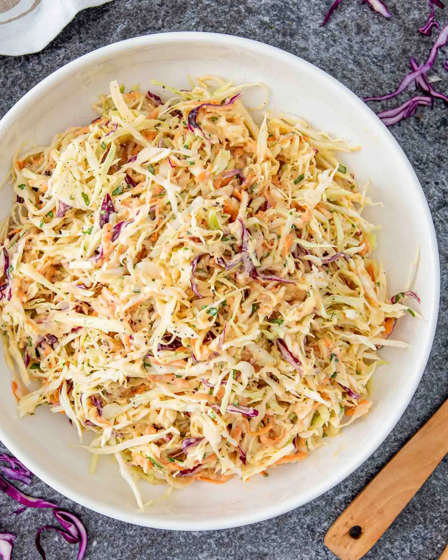 freshly made coleslaw in a white bowl.