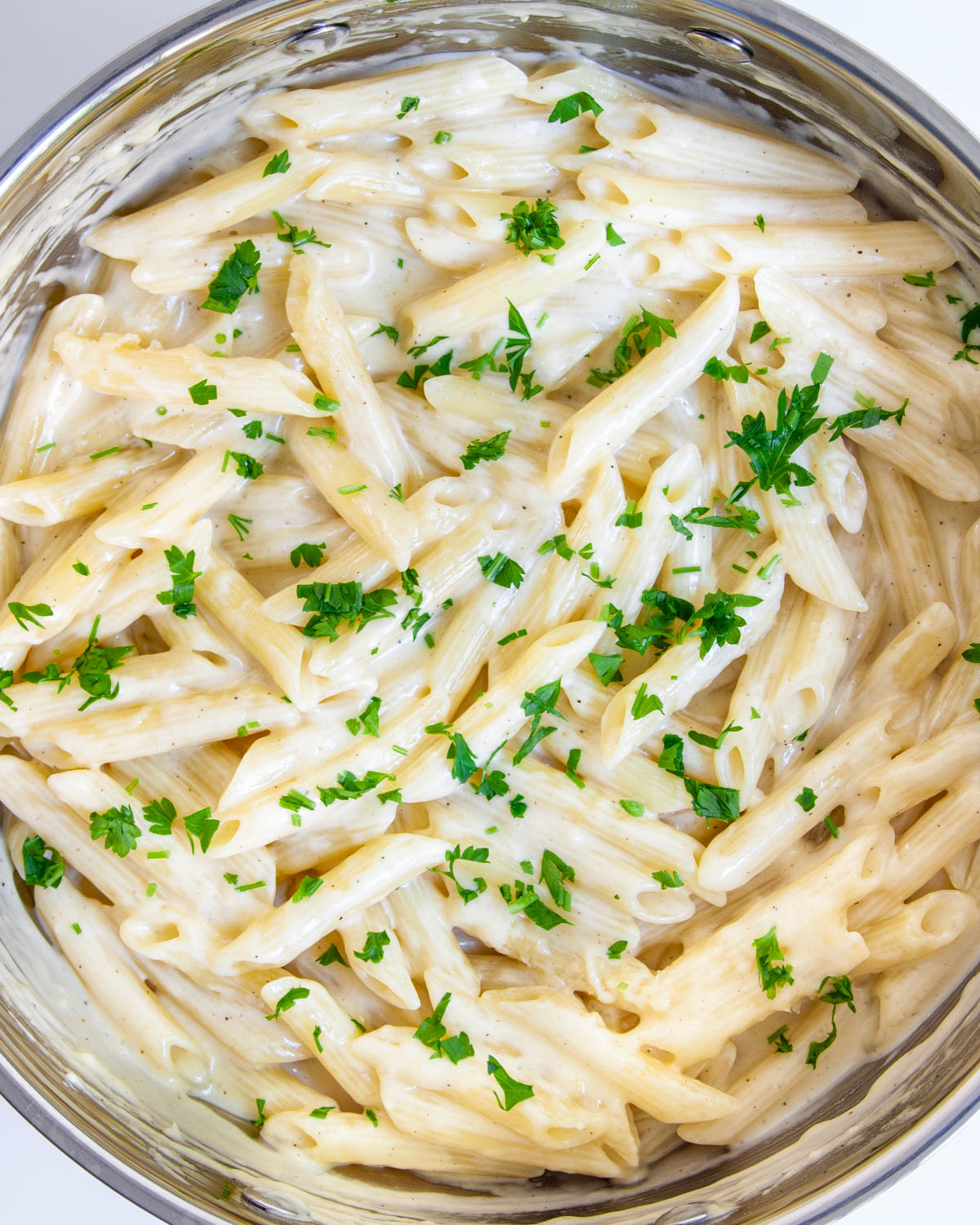 creamy parmesan pasta in one pot garnished with parsley