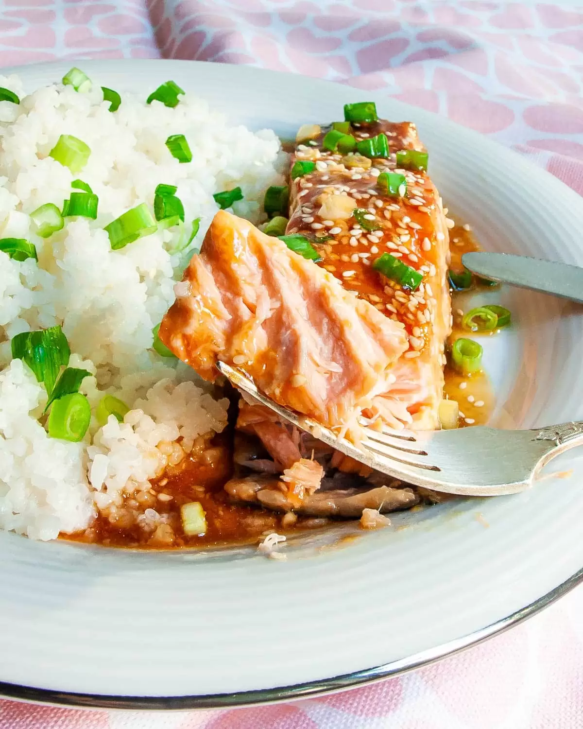 teriyaki salmon with coconut rice in a white plate