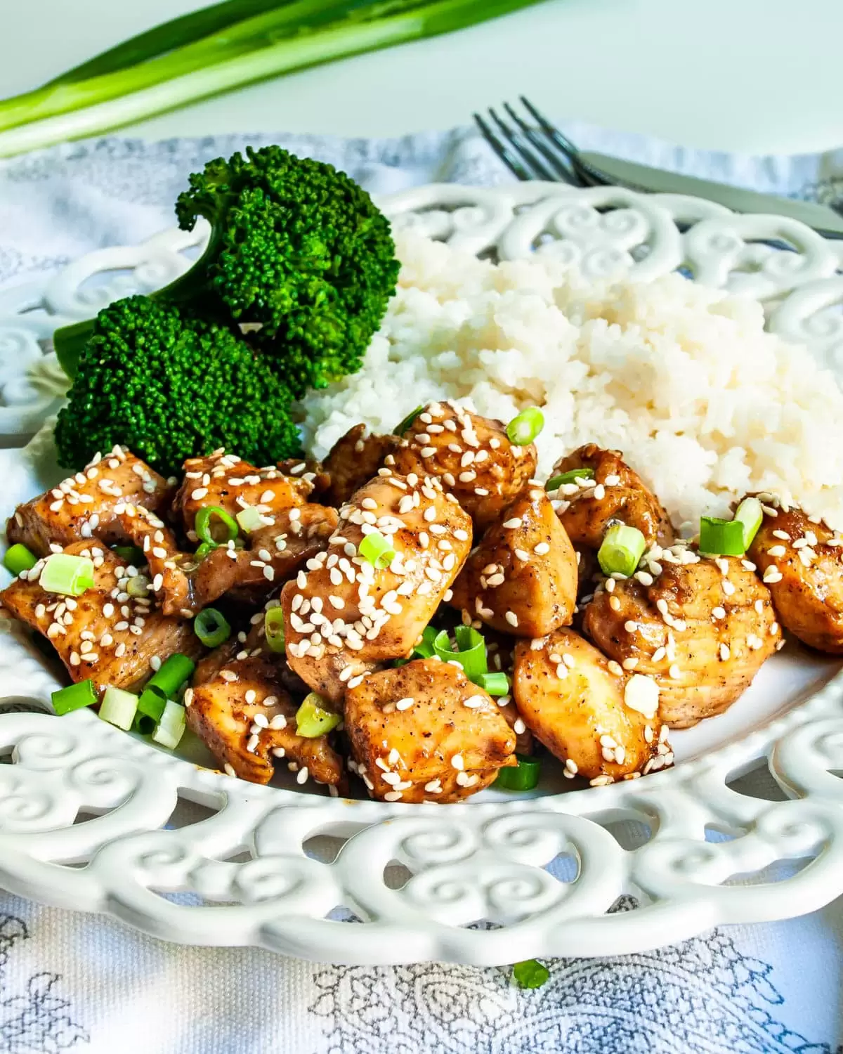 chicken teriyaki with rice and broccoli on a white plate