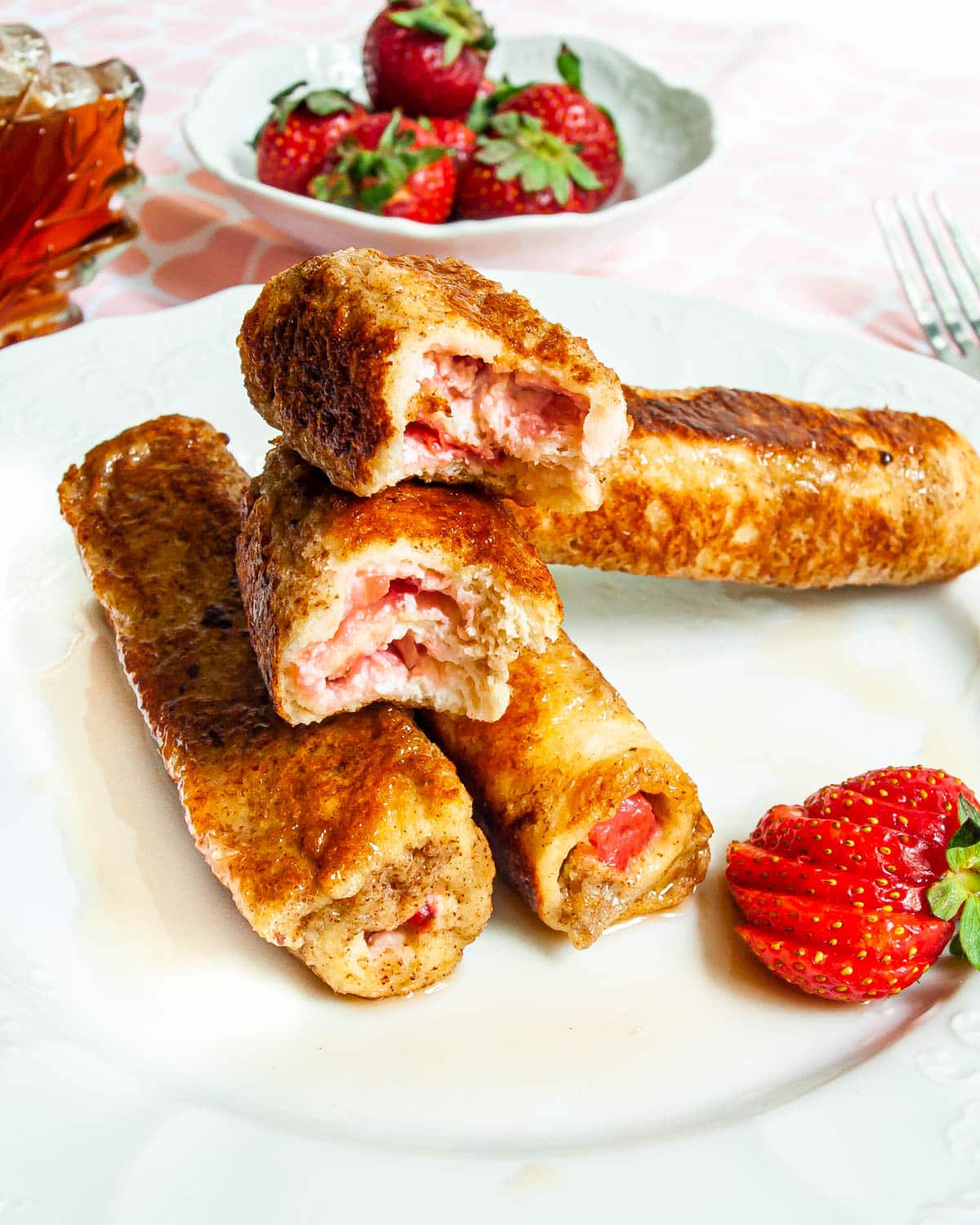 Strawberry Cream Cheese French Toast Roll Ups on a white plate