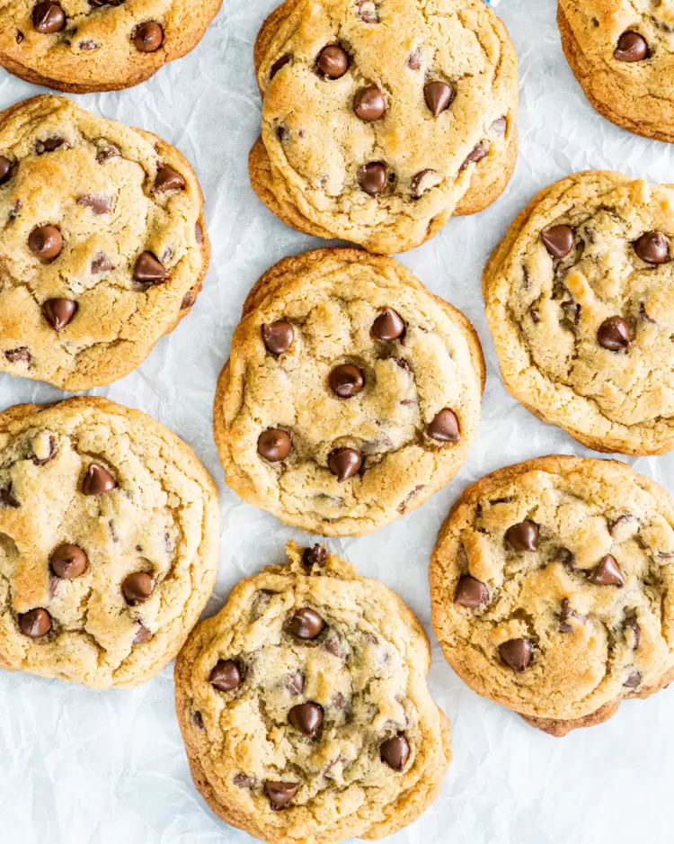 overhead shot of chocolate chip cookies on parchment paper