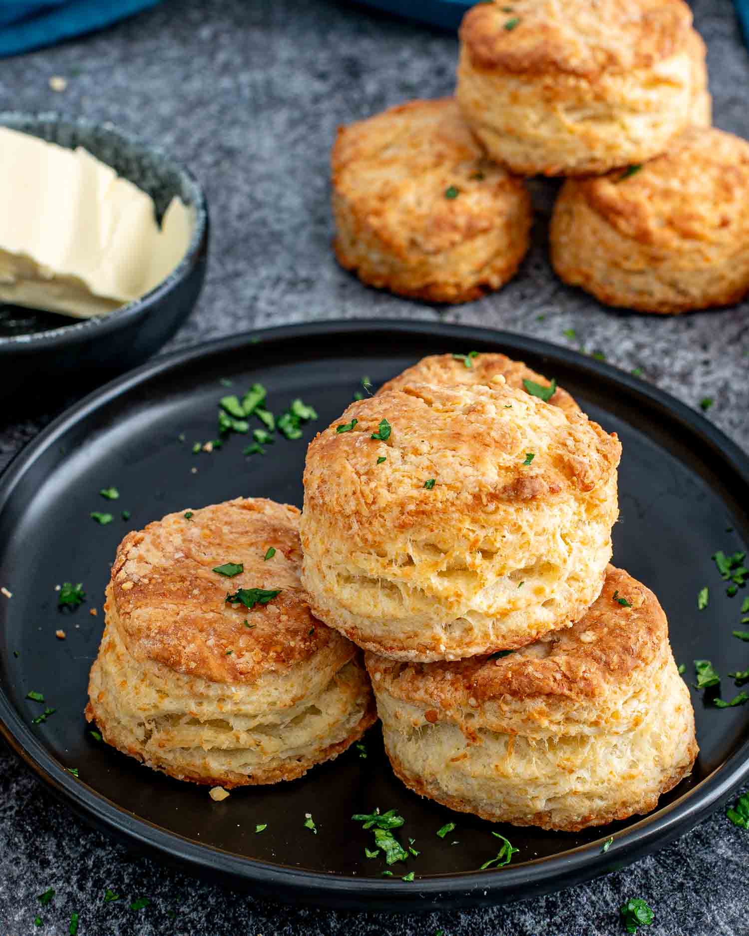 a stack of freshly baked buttermilk parmesan biscuits.