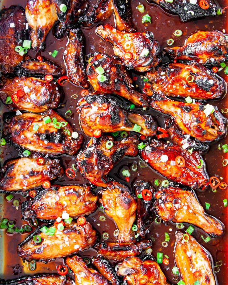 overhead shot of sticky honey soy chicken wings in a baking sheet or roasting pan