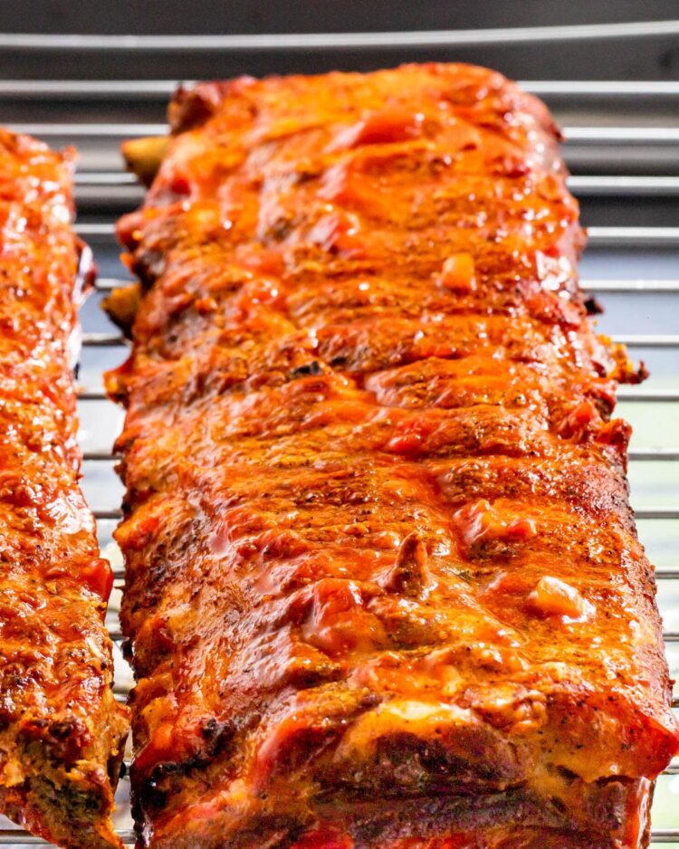 a close up picture of a baby back rib on a roasting rack