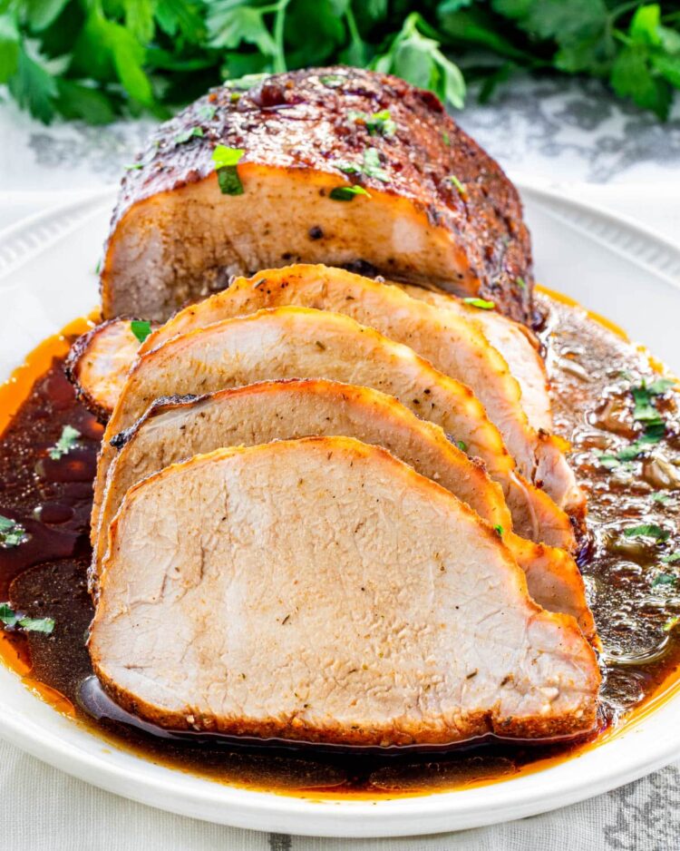 pork loin sliced with balsamic glaze on a platter