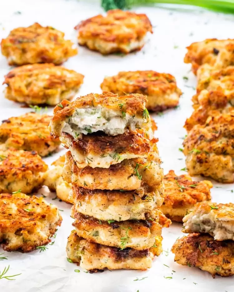 a stack of chicken fritters on parchment paper