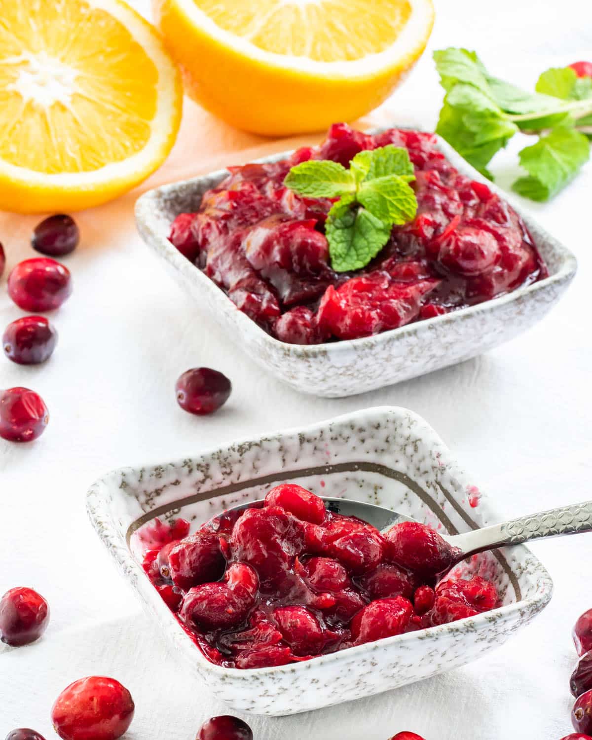 cranberry sauce in two little bowls garnished with mint