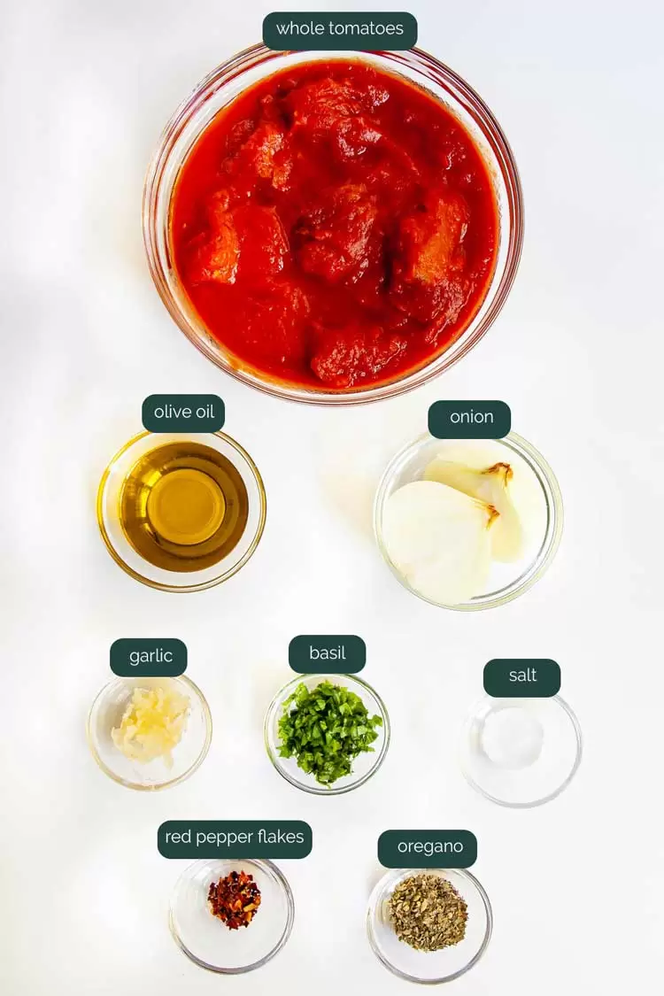 overhead shot of all the ingredients needed to make marinara sauce