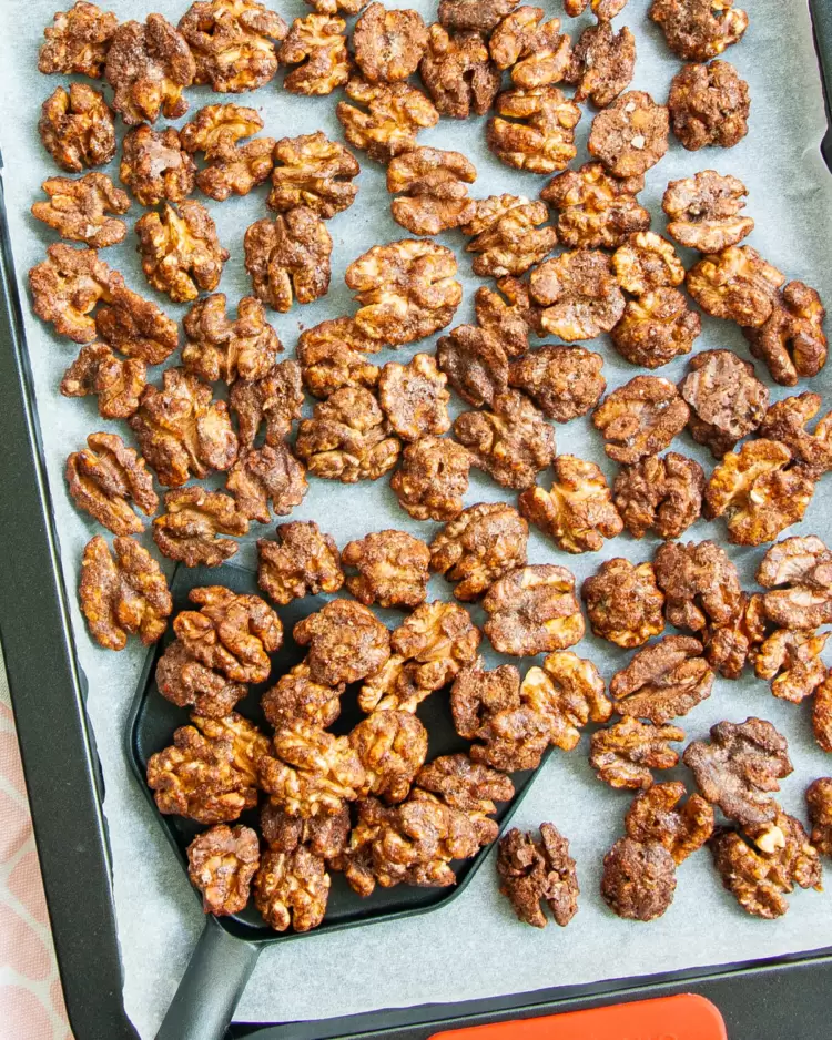 overhead shot of candied walnuts on a baking sheet