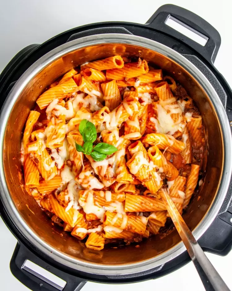 baked ziti in an instant pot garnished with some fresh basil