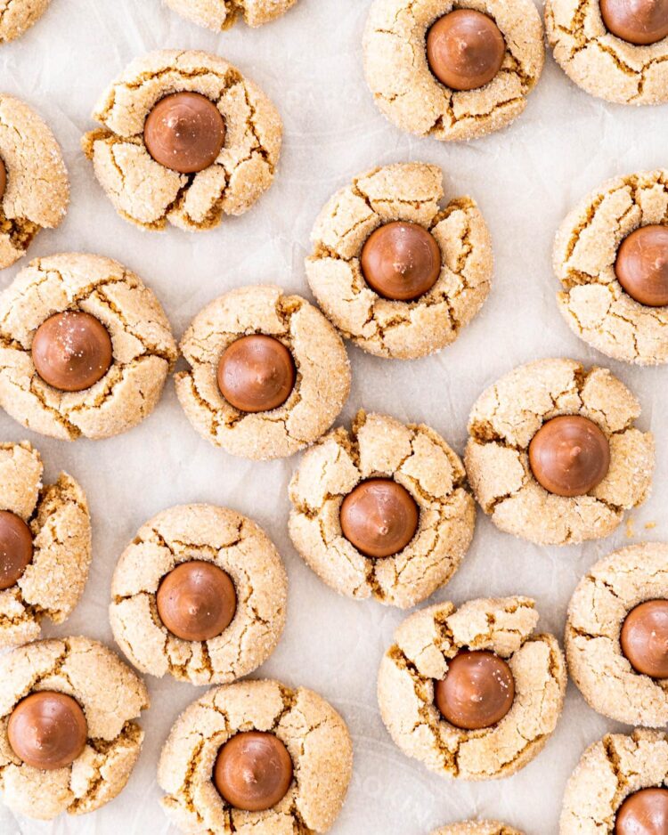 overhead shot of peanut butter blossoms on a piece of parchment paper