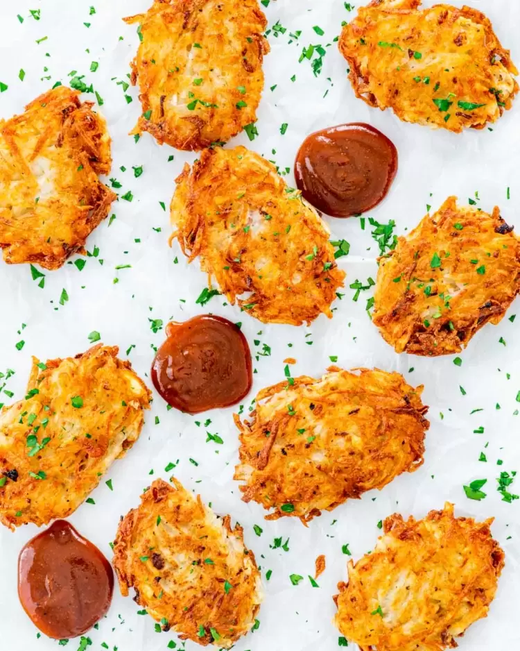 overhead shot of hash browns on parchment paper garnished with parsley 