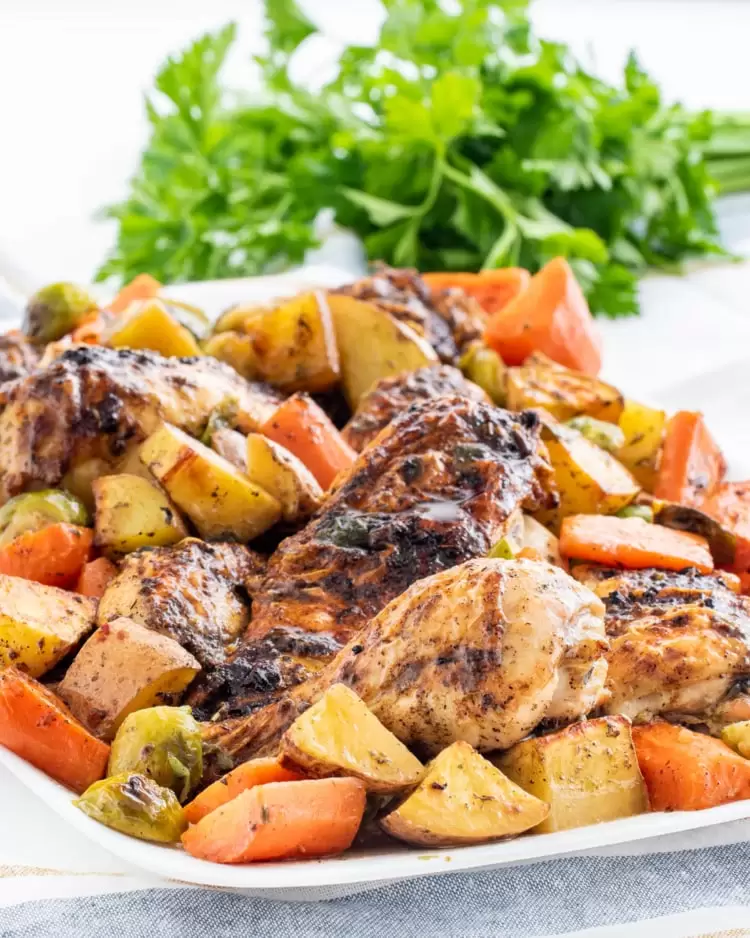 roasted chicken and vegetables on a white serving platter