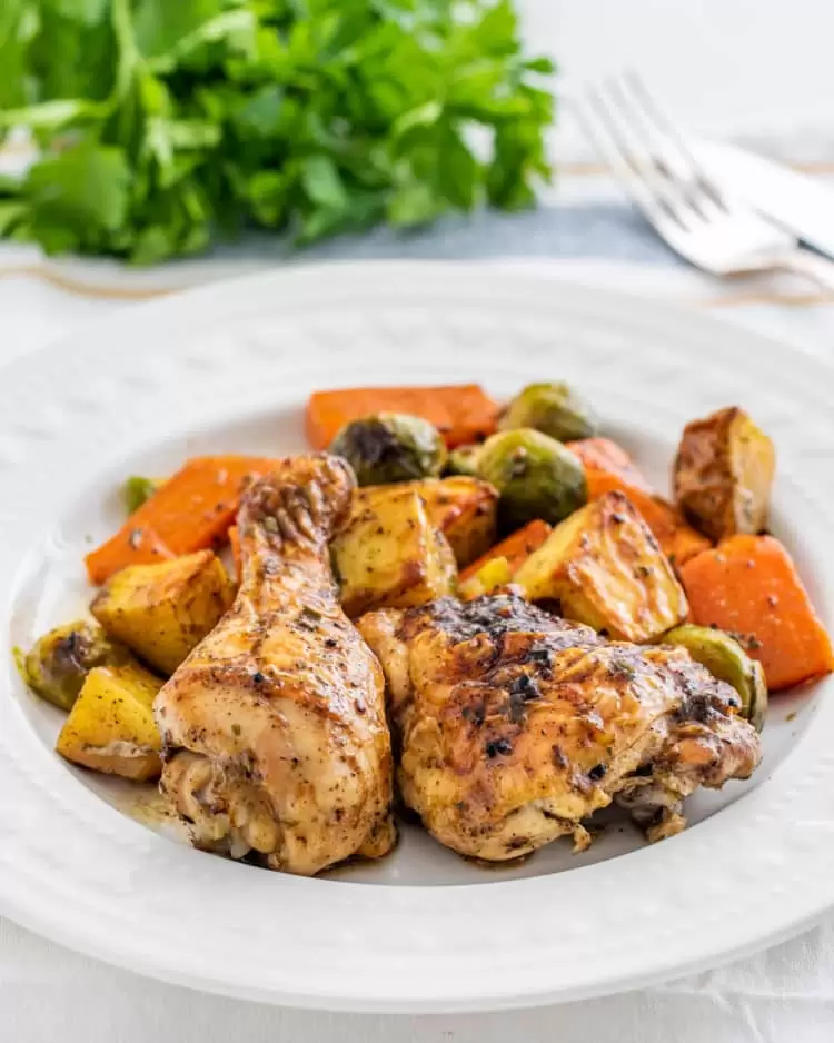 roasted chicken and vegetables on a white plate