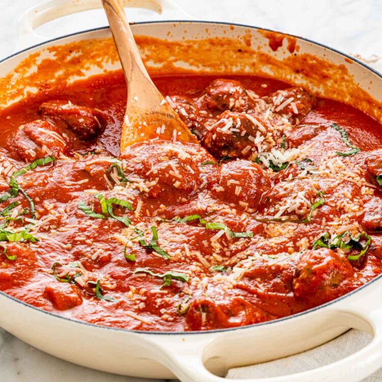 a large skillet filled with meatballs and marinara sauce