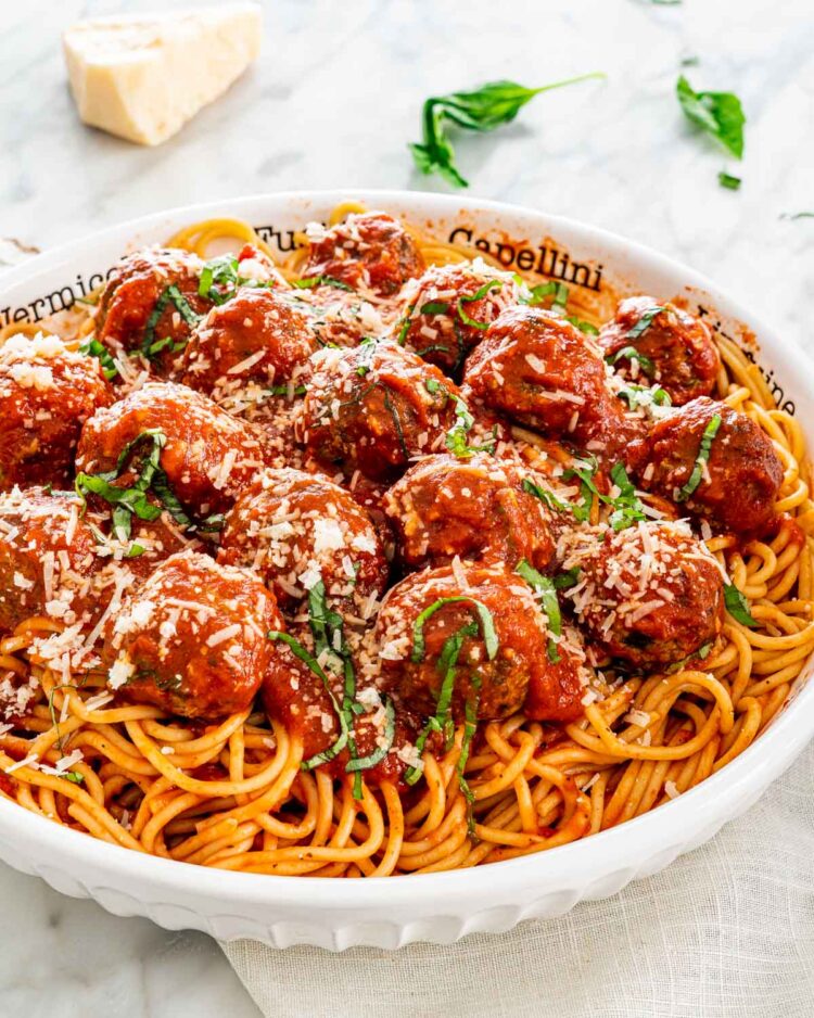 a large bowl filled with spaghetti and meatballs