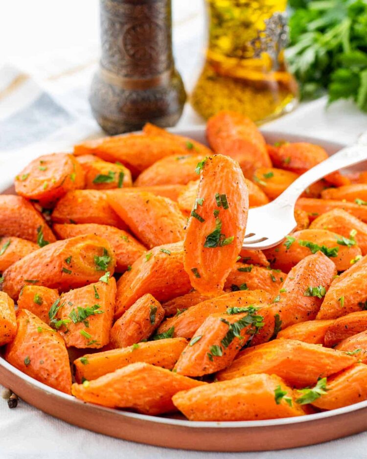 s plate full of oven roasted carrots with a fork stuck in one