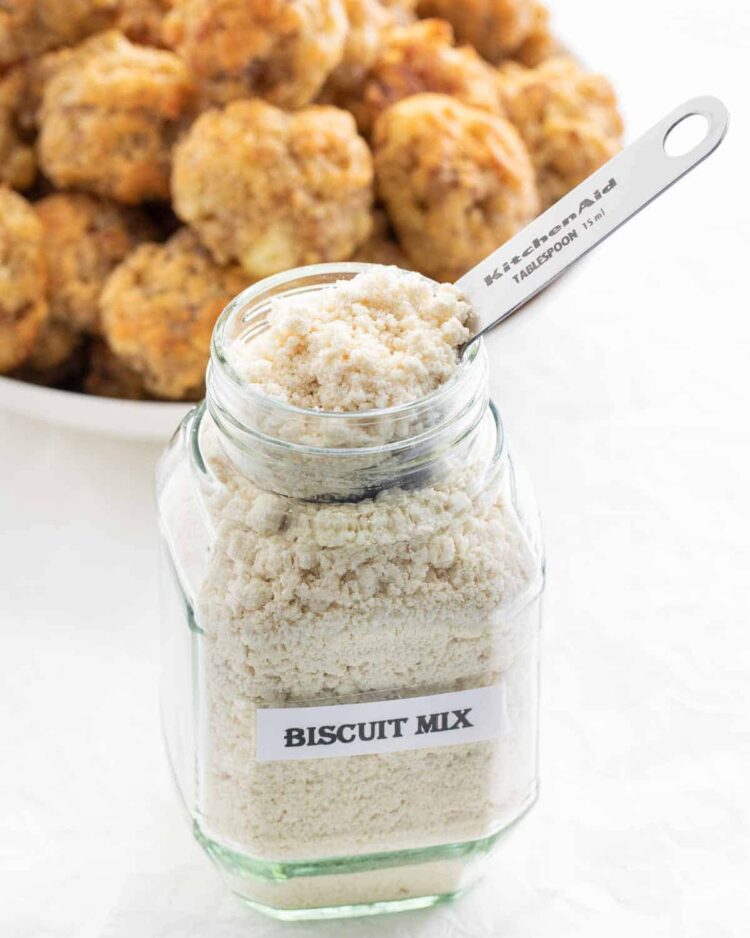 homemade biscuit mix in a jar with a scoop inside