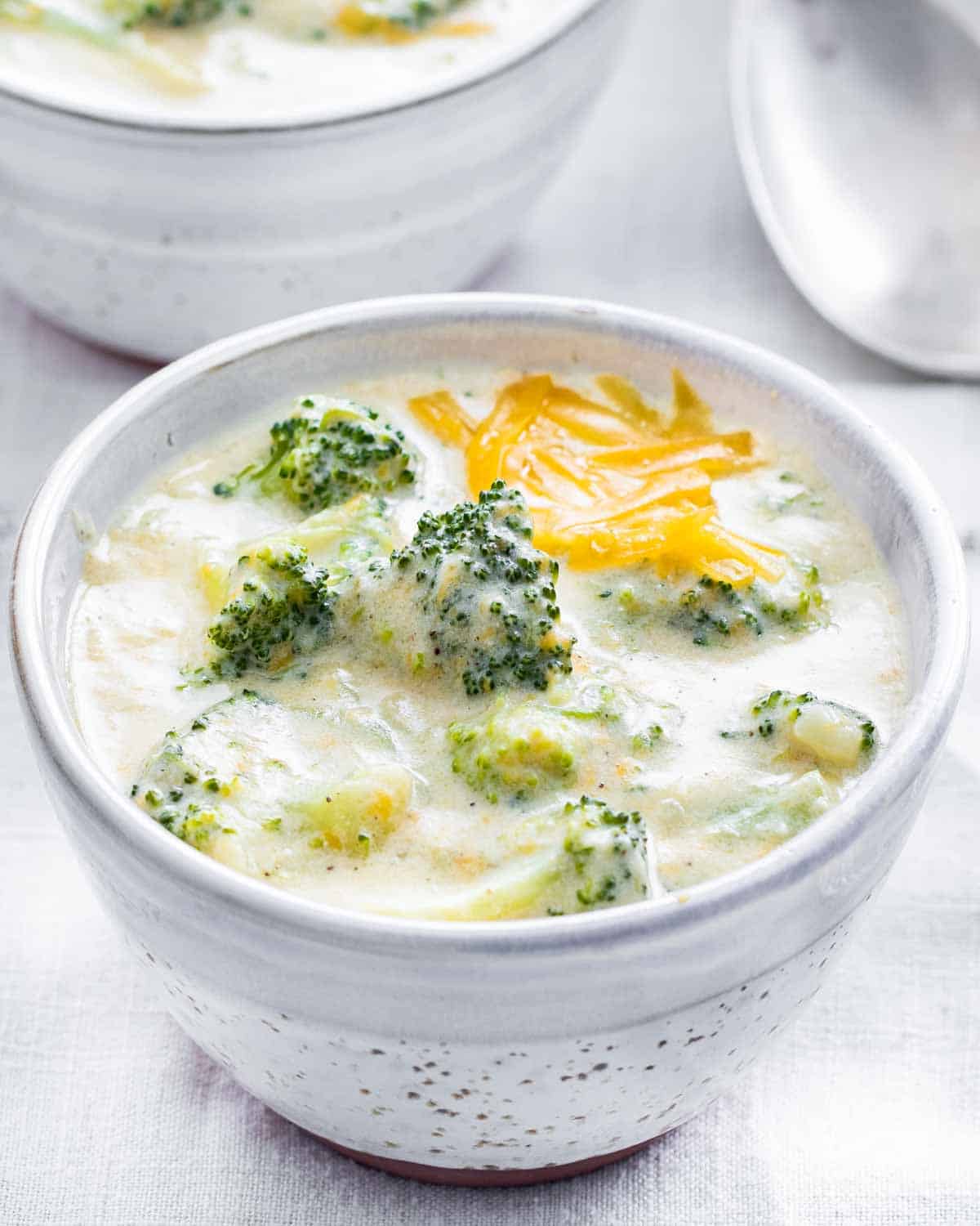 side view shot of a small bowl full with broccoli cheddar soup