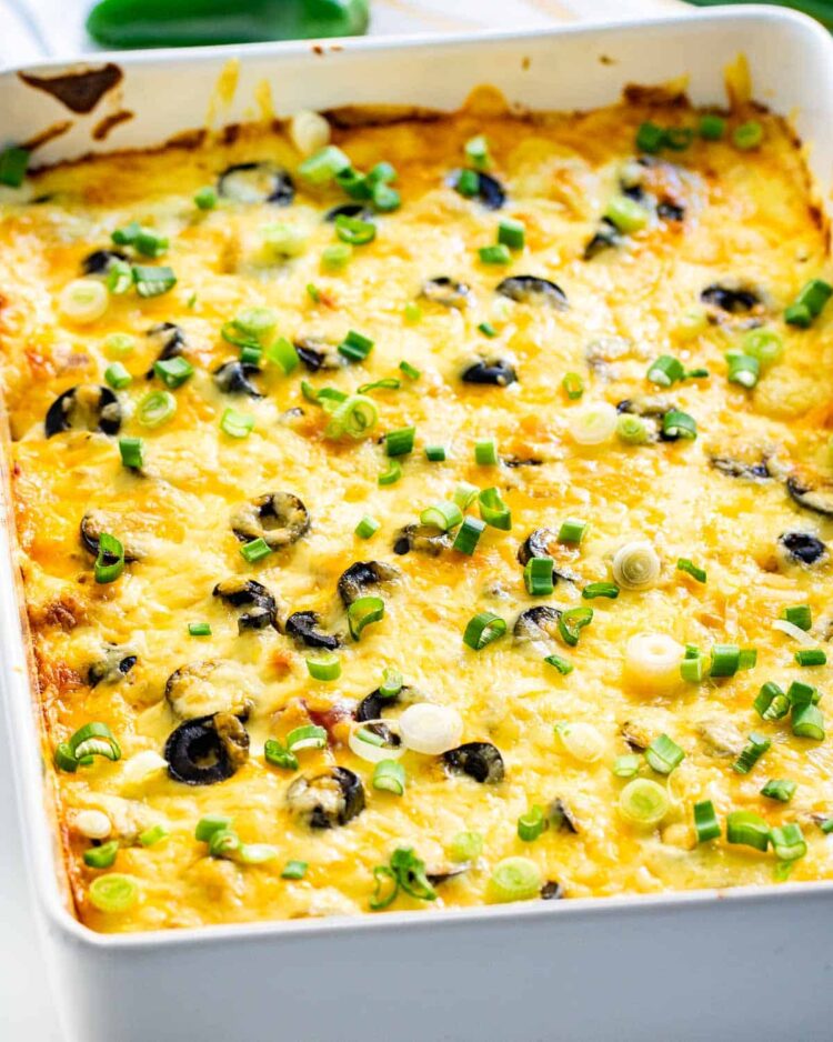 a mexican casserole fresh out of the oven topped with green onions