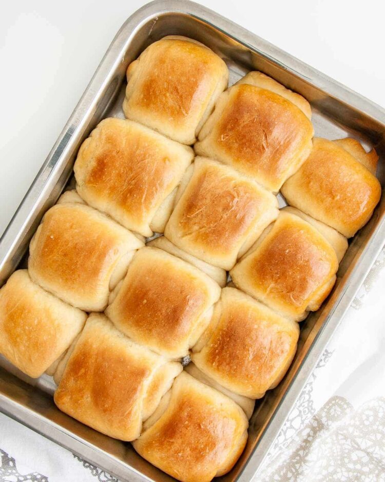 overhead shot of a pan full of dinner rolls fresh out of the oven and brushed with butter