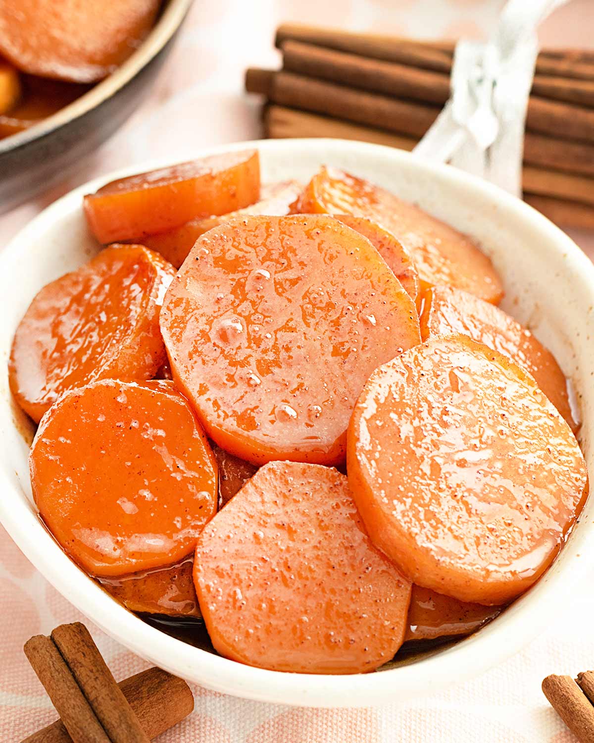 candied yams in a white bowl.