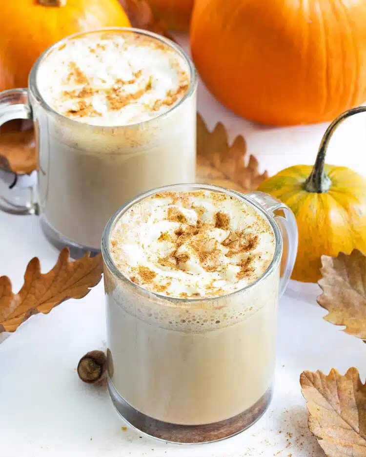 two cups filled with pumpkin spice latte.