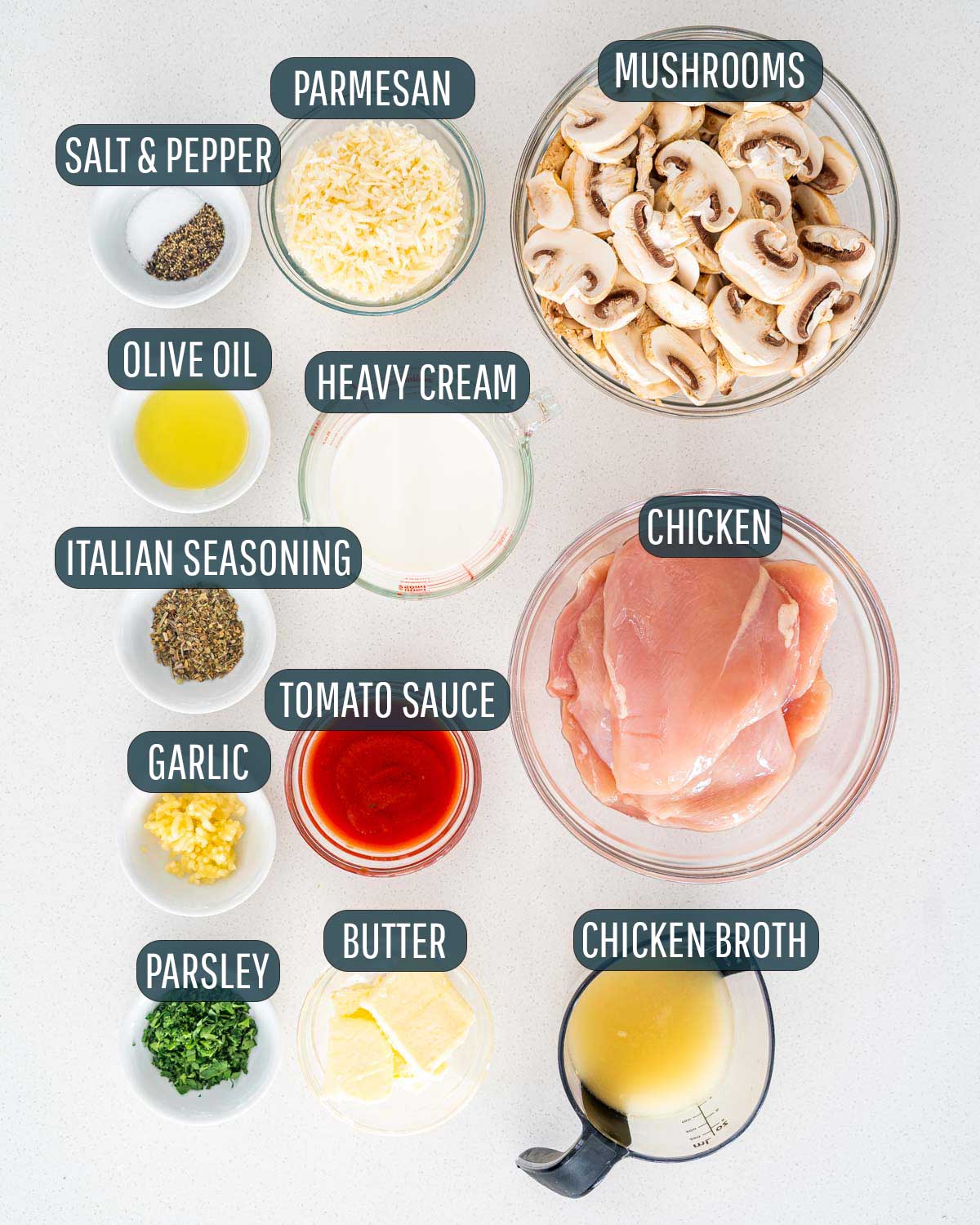 overhead shot of all ingredients needed to make creamy parmesan chicken and mushrooms.