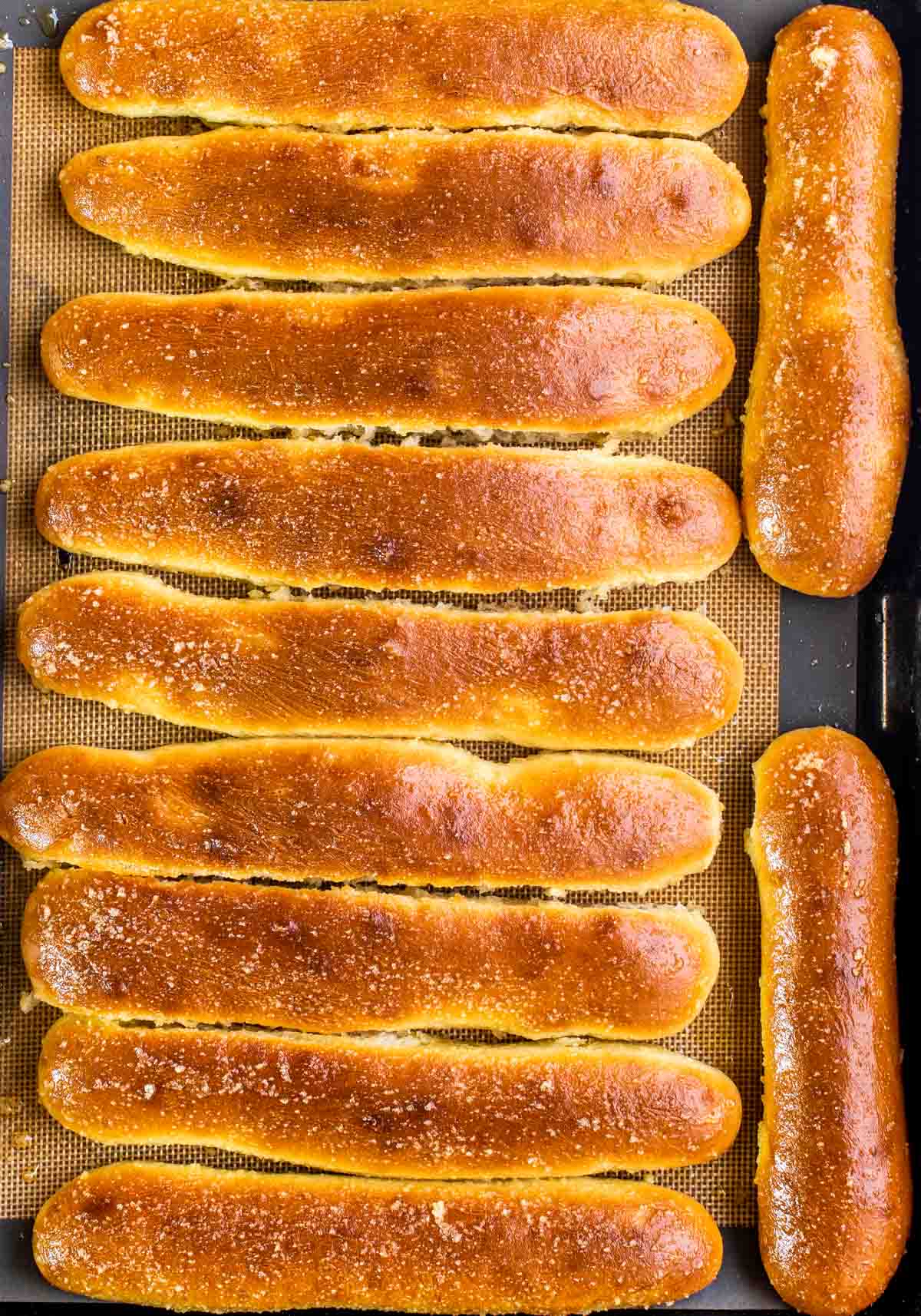 breadsticks on a baking sheet fresh from the oven.