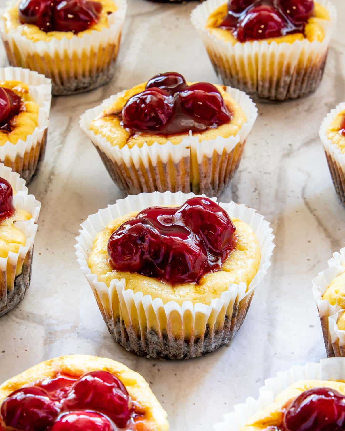 mini cherry cheesecakes in muffin liners.