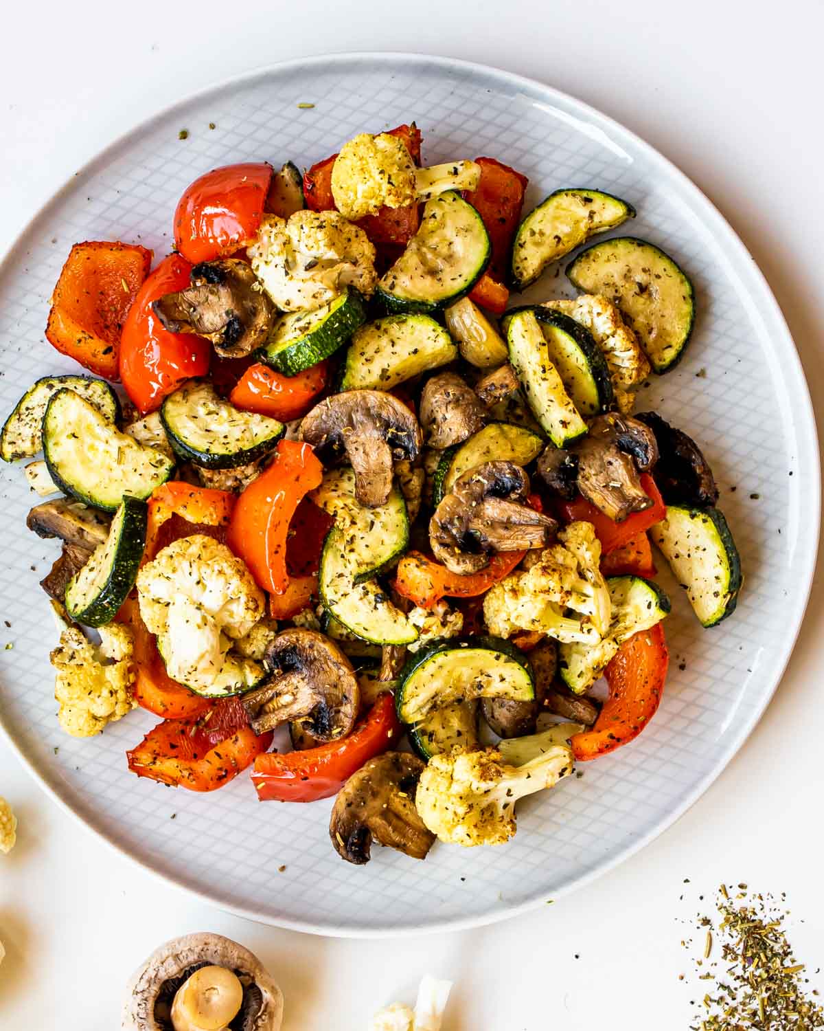 roasted vegetables made in the air fryer on a white plate.