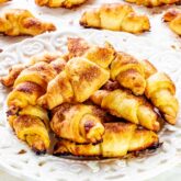 a few rugelach cookies on a white plate.