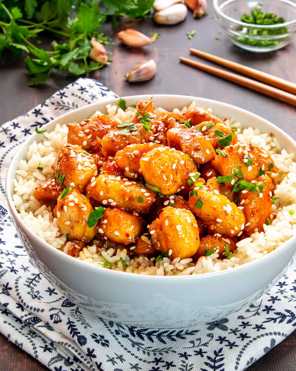honey garlic chicken bites on a bed of rice in a bowl.