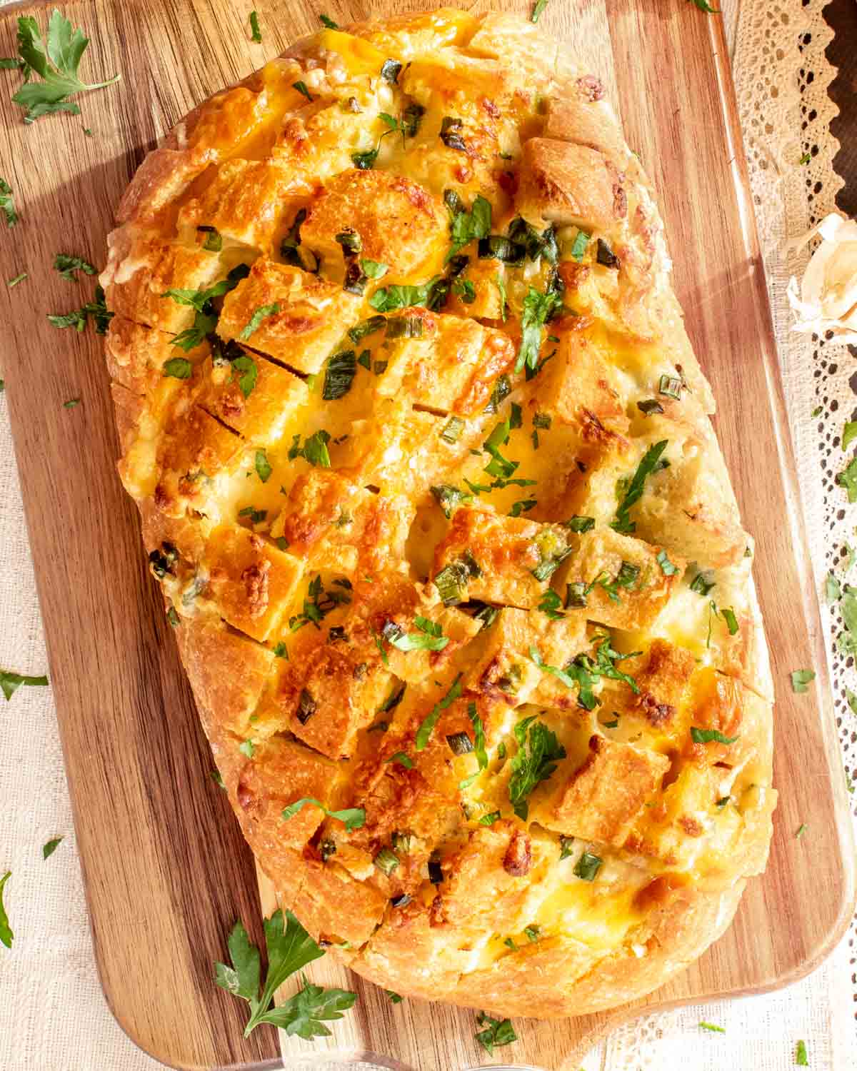 cheese pull apart bread that was made in an air fryer on a cutting board.