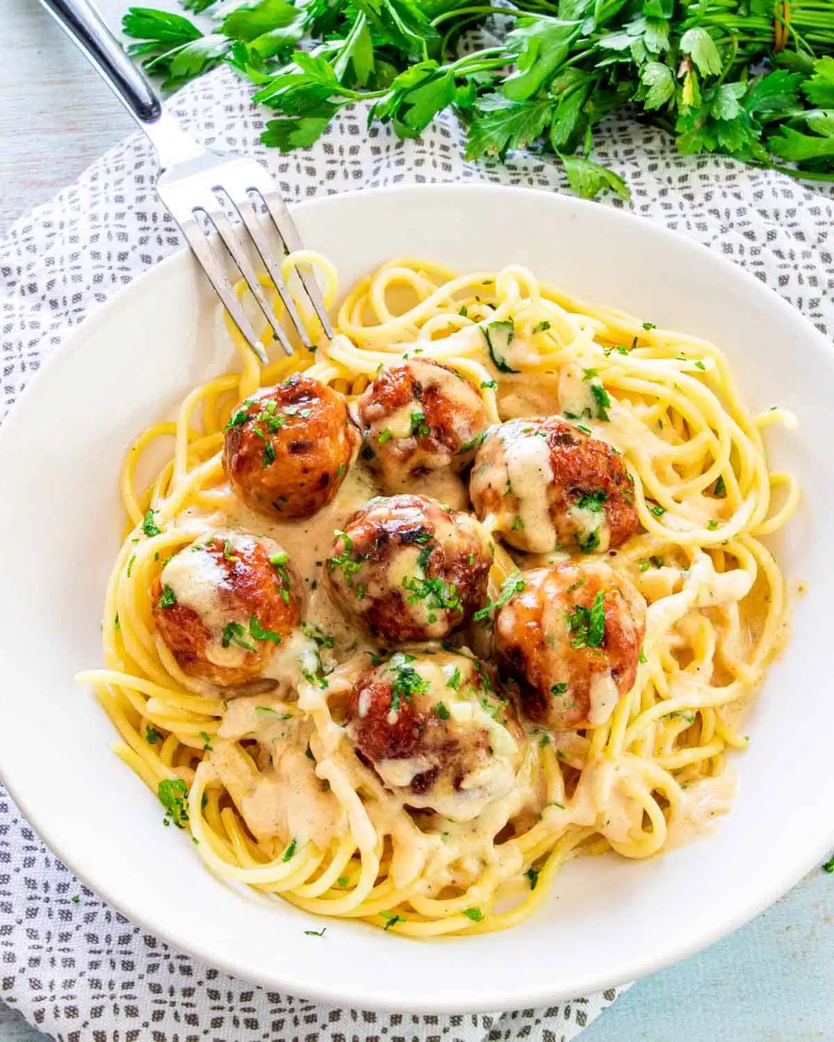 chicken meatballs with alfredo sauce and spaghetti.