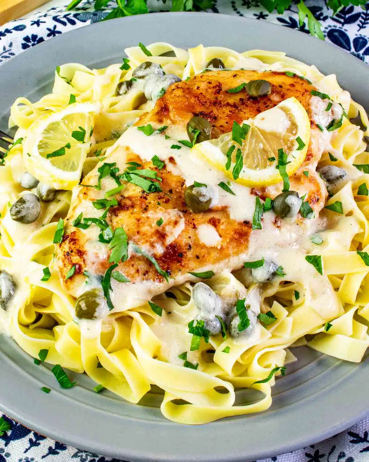 creamy chicken piccata on a bed of noodles.
