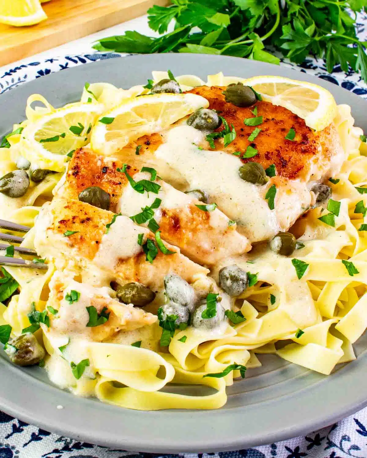 creamy chicken piccata on a bed of noodles.
