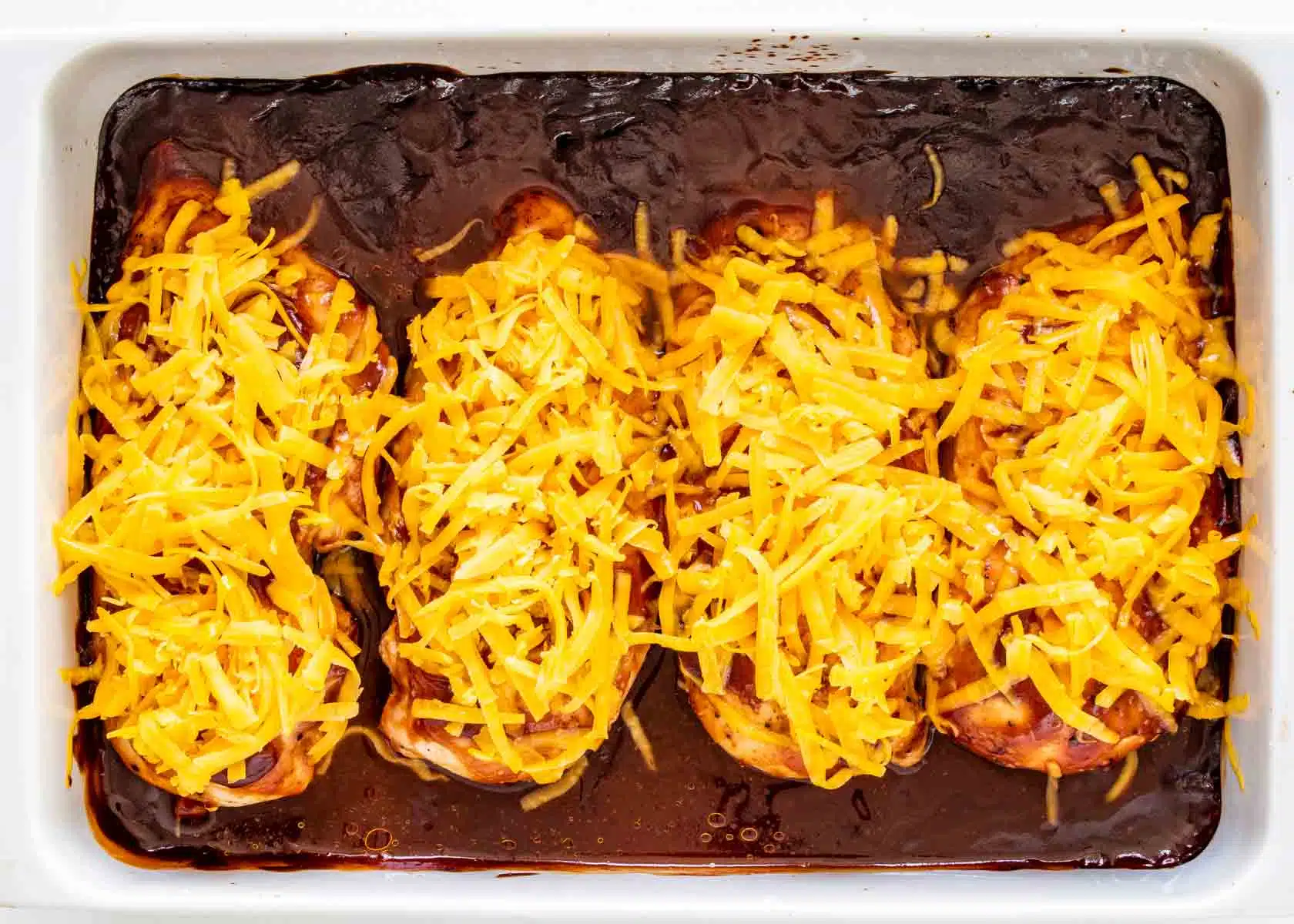 monterey chicken with cheese on top in a baking dish.