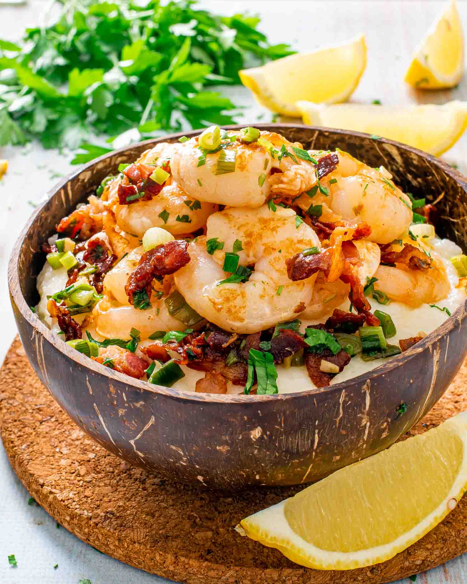 shrimp and grits in a coconut bowl.