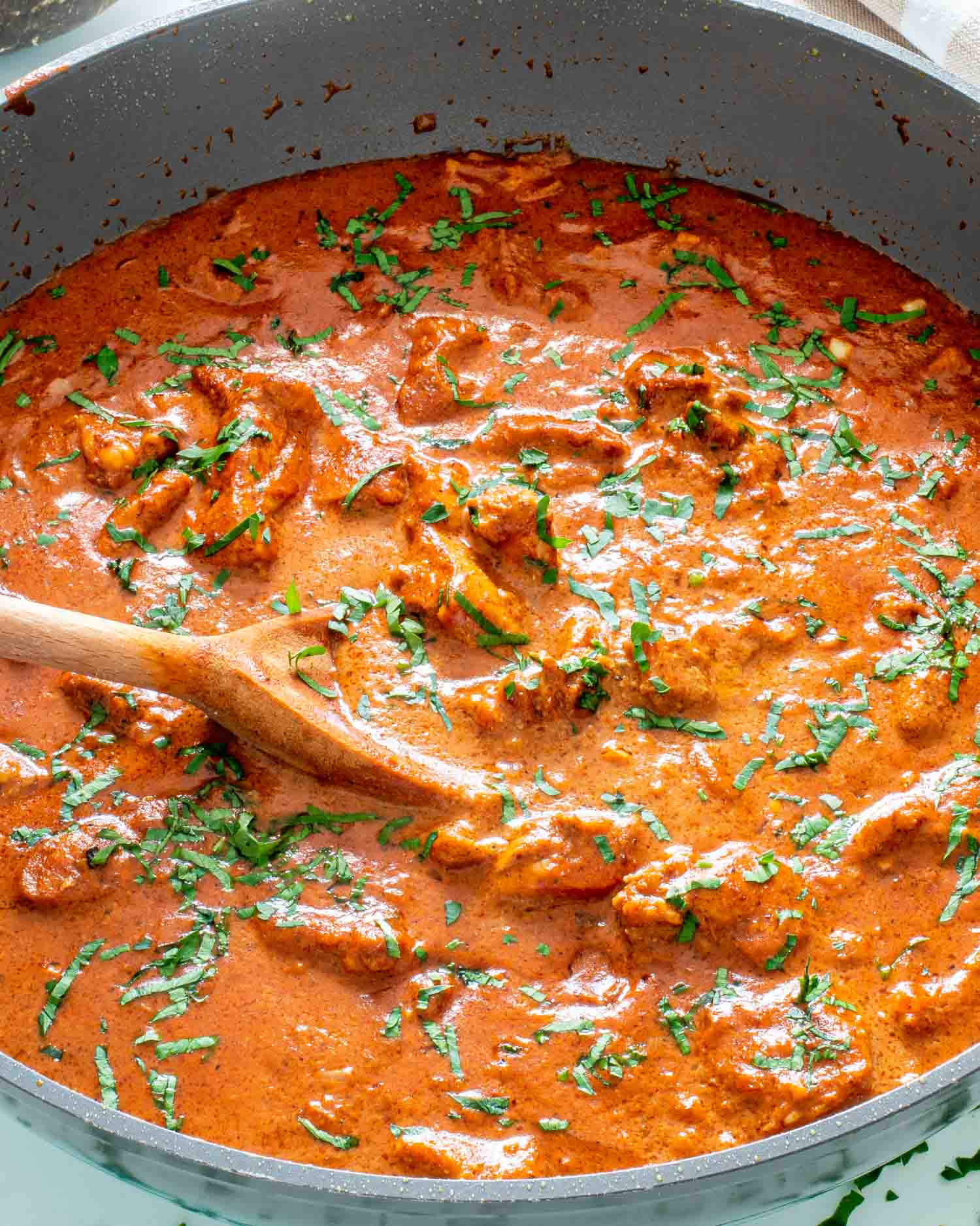 freshly made chicken tikka masala in a skillet garnished with cilantro.