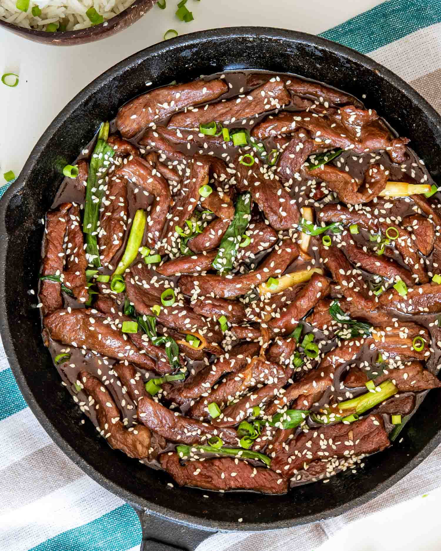 freshly made chinese sizzling beef in a cast iron skillet.