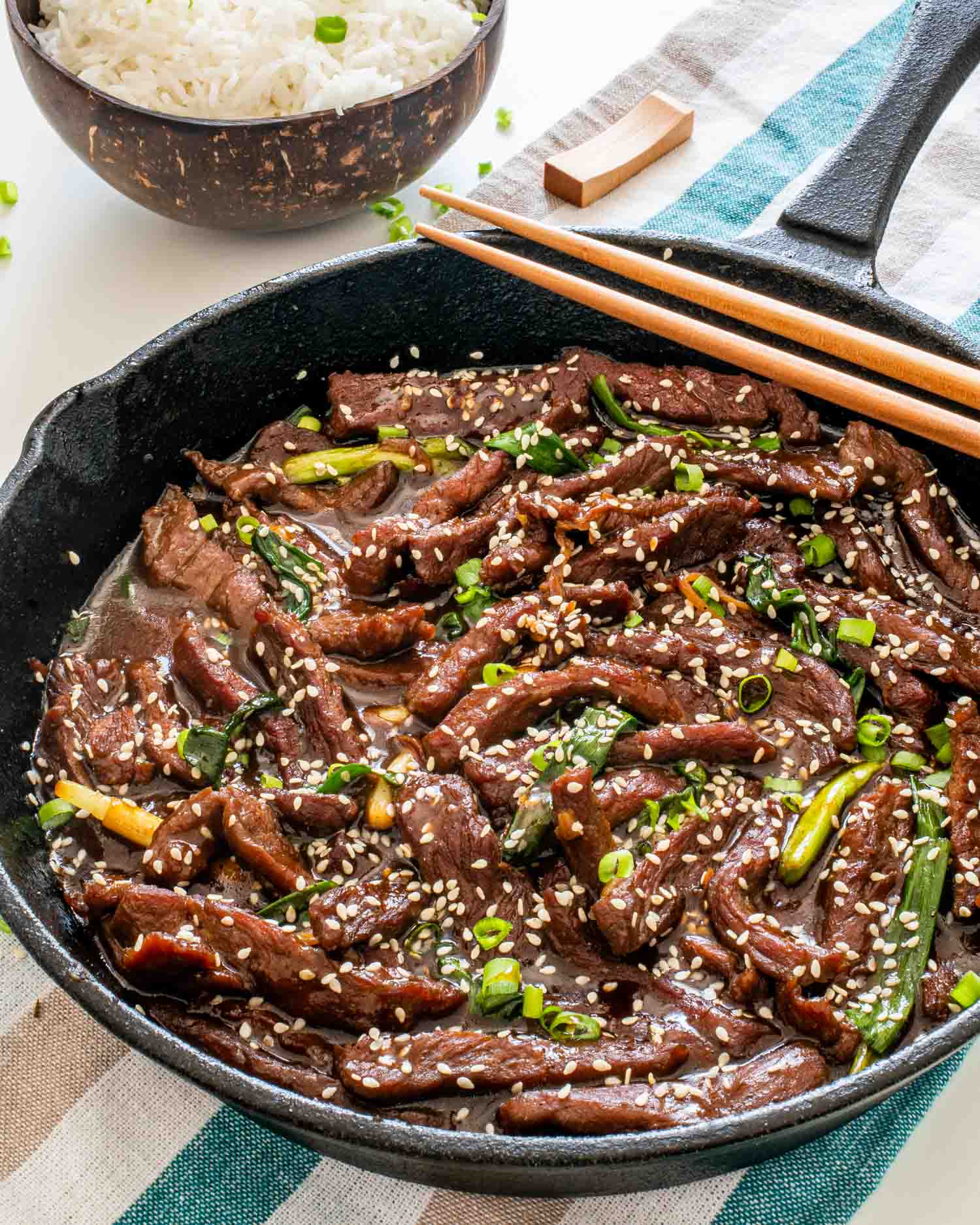 freshly made chinese sizzling beef in a cast iron skillet.