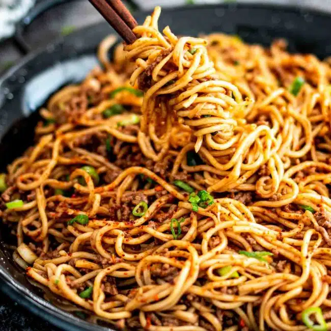 freshly made asian ground beef noodles in a skillet.