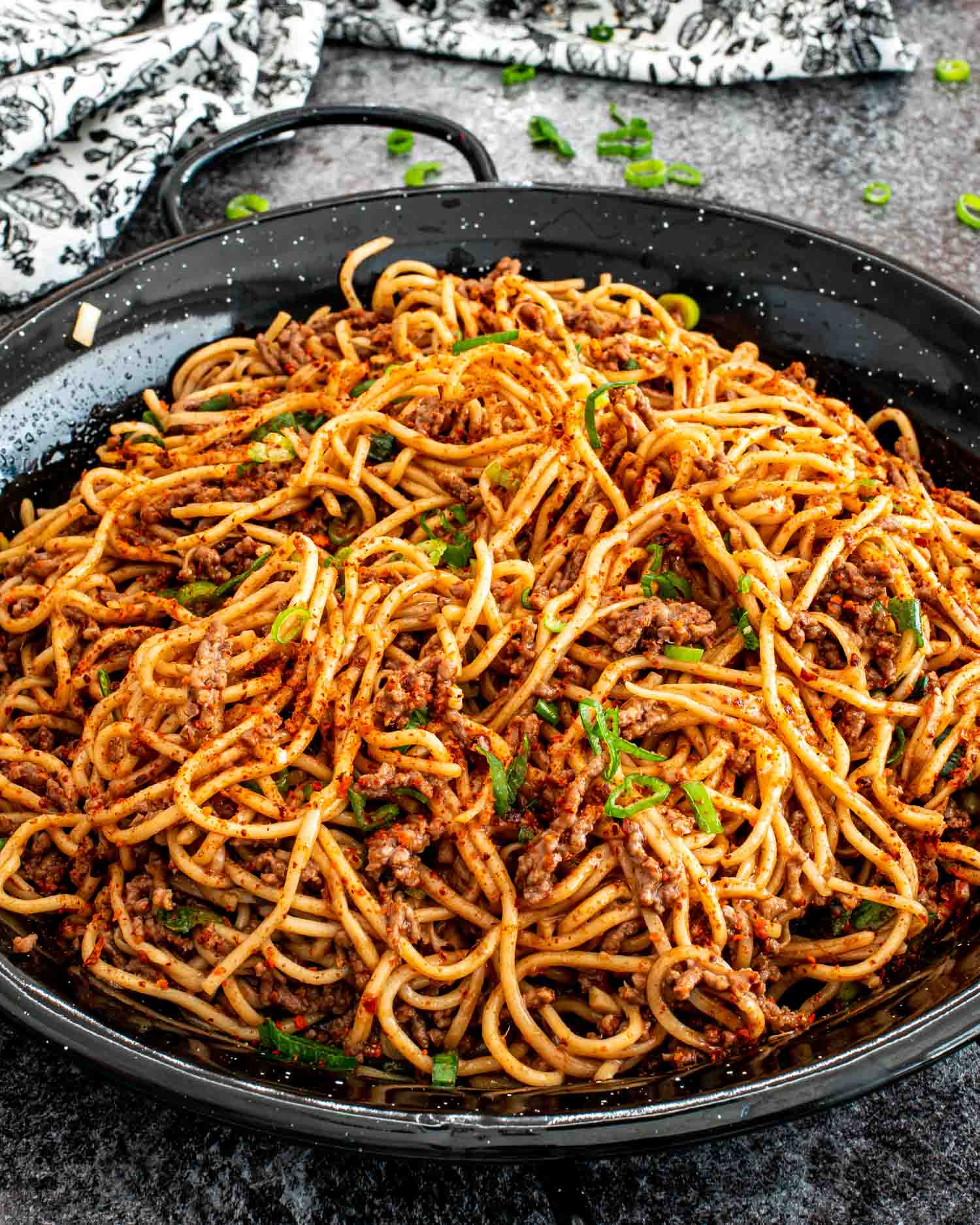 freshly made asian ground beef noodles in a pan.