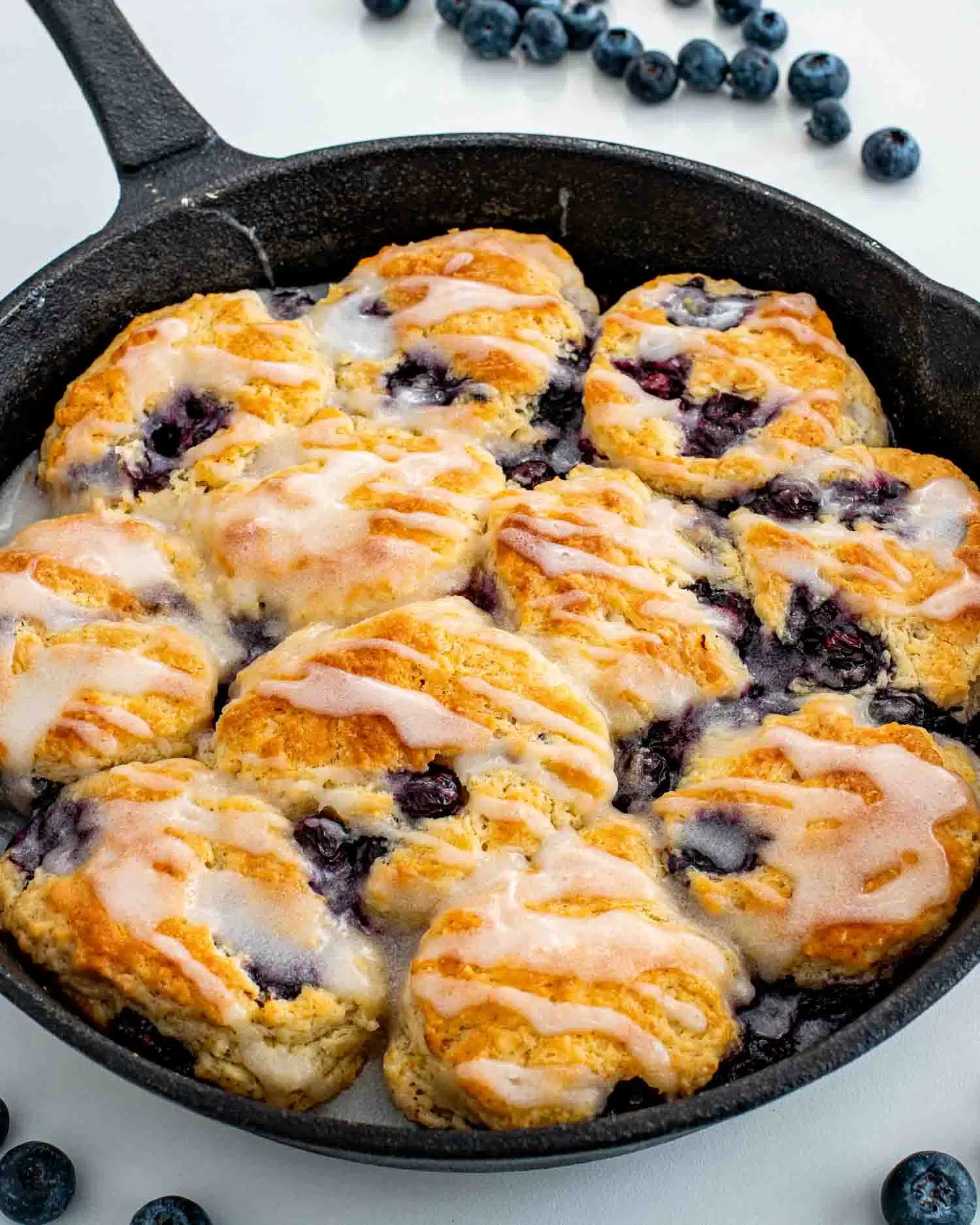freshly baked blueberry biscuits in a black cast iron skillet.