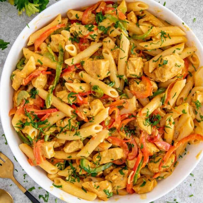 freshly made buffalo chicken pasta in a white bowl.